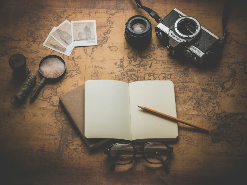 Collage with notebook, map, photographs